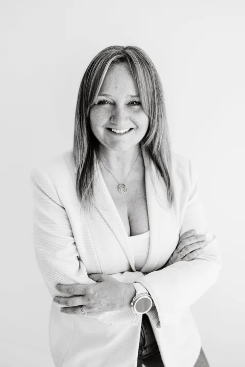 Emma Kneale, founder of Jigsaw Consulting, in a white blazer with arms folded