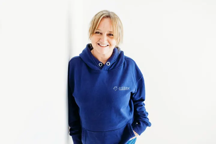 Emma Kneale, founder of Jigsaw Consulting, smiling in a navy Jigsaw hoodie