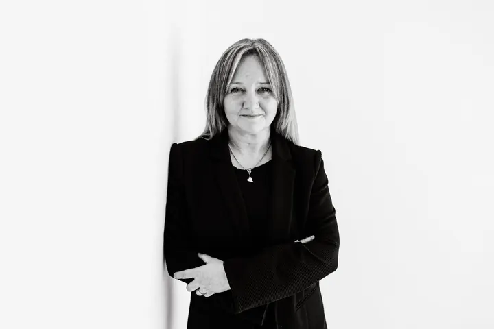 Emma Kneale in a dark blazer with arms folded, ready to review your back office